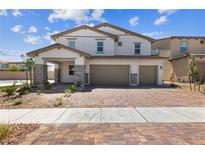 Two-story house with three-car garage, stone accents, and landscaped yard at 1070 Kelly Brook Ln, Henderson, NV 89011