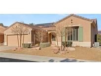 One-story house with solar panels, landscaping, and a two-car garage at 2000 Poppywood Ave, Henderson, NV 89012