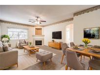 Bright living room features a fireplace, dining area, and ample seating at 3320 S Fort Apache Rd # 125, Las Vegas, NV 89117