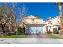 Charming two-story home with a well-manicured lawn and a two-car garage and desert landscaping at 433 Jubilation Dr, Las Vegas, NV 89145