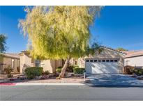 Single-story house with attached garage, mature tree, and landscaped yard at 4705 Bersaglio St, Las Vegas, NV 89135