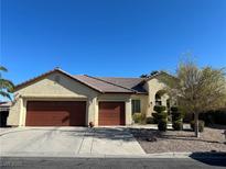 Tan two-story house with brown roof and two-car garage at 5016 Wayfaring Tree Ave, Las Vegas, NV 89131