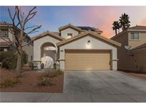 Charming two-story home with a well-maintained lawn and a two-car garage at 5028 Frozen Springs Ct, Las Vegas, NV 89130