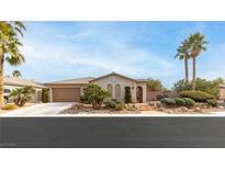 Single-story home with landscaped yard and two-car garage at 6422 Hughes Springs Dr, Las Vegas, NV 89131