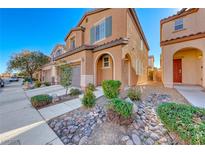 Two story house with a two car garage and landscaped front yard at 7683 Jasmine Falls Dr, Las Vegas, NV 89179