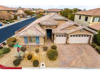 Single-story house with three-car garage, and landscaped yard at 7976 Sleeping Lily Dr, Las Vegas, NV 89178