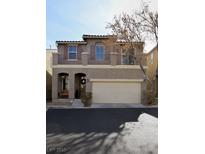 Two-story tan house with attached garage and balcony at 8415 Quarentina Ave, Las Vegas, NV 89149