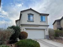 Two-story house with attached garage and landscaping at 9553 Madsen Glen Ct, Las Vegas, NV 89166