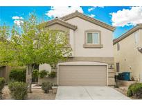 Two-story house with beige exterior, attached garage, and landscaping at 9757 Marcelline Ave, Las Vegas, NV 89148