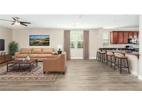 Open living room with hardwood floors, neutral walls, and access to kitchen at 3186 Del Terra Ave, Henderson, NV 89044