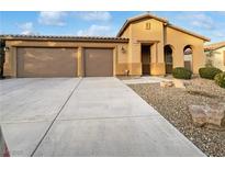 Single-story house with three-car garage and desert landscaping at 6162 Denton Ranch Rd, Las Vegas, NV 89131