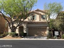 Two-story house with a landscaped yard and attached garage at 8708 Gateway Glen Dr, Las Vegas, NV 89178