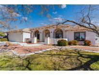 Single-story home with arched entryway and landscaped yard at 2061 Iroquois Ave, Pahrump, NV 89048