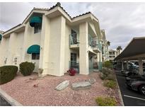 Exterior view of condo building with parking and landscaping at 3550 Bay Sands Dr # 1017, Laughlin, NV 89029