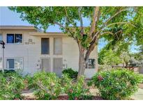 Tan two-story building with landscaping and walkway at 4770 Topaz St # 77, Las Vegas, NV 89121