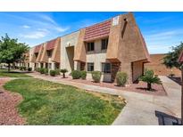 Tan two-story building with red tile roofs, landscaping, and walkways at 5493 Indian River Dr # 383, Las Vegas, NV 89103