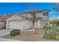 Two-story house with attached garage and well-maintained landscaping at 5863 Capsicum Ct, Las Vegas, NV 89118