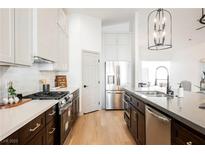 Modern kitchen features stainless steel appliances, two-tone cabinets, and a large island at 5904 Negril Ave, Las Vegas, NV 89130