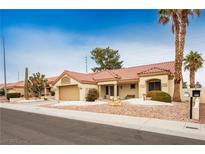 Single-story house with a terracotta tile roof, desert landscaping, and a two-car garage at 8528 Festival Dr, Las Vegas, NV 89134