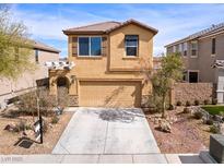 Charming two-story home showcasing desert landscaping and a two-car garage, perfect for modern living at 1012 Water Cove St, Henderson, NV 89011