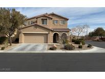 Two story home with a two car garage, mature landscaping, and an arched front entryway at 11290 Hazel Rock St, Las Vegas, NV 89179