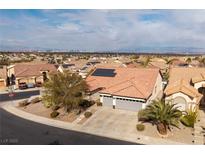 Aerial view of single-story house with solar panels, two-car garage, and desert landscaping at 1592 Bamboo Bay Dr, Henderson, NV 89012