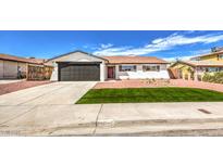 Remodeled single-story home with artificial turf and new landscaping at 1700 Breezewood Dr, Las Vegas, NV 89108