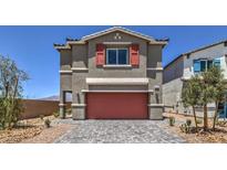 Two-story house with gray siding, red garage door, and landscaping at 2637 Snapdragon Falls Ave # 105, North Las Vegas, NV 89081