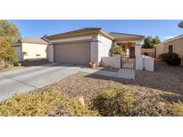 Charming single-story home with a two-car garage and a desert-landscaped front yard at 3025 Seaford Peak Dr, Henderson, NV 89052