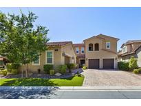 Two-story house with tan siding, landscaped lawn, and a three-car garage at 4063 Villa Rafael Dr, Las Vegas, NV 89141