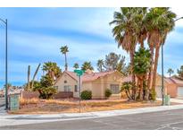 Single-story house with a landscaped yard and palm trees at 4416 Inez Dr, Las Vegas, NV 89130