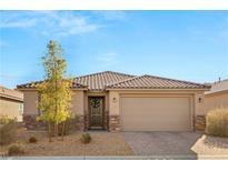 Single-story home with tile roof, neutral color scheme, and a two-car garage at 8113 Brown Clay Ave, Las Vegas, NV 89113