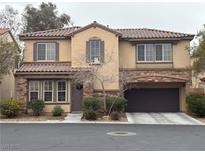 Charming two-story home featuring a well-maintained lawn and an attached two-car garage at 8396 Waylon Ave, Las Vegas, NV 89178