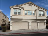 Two-story townhome with three-car garage and landscaped front yard at 8800 Roping Rodeo Ave # 103, Las Vegas, NV 89178