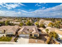 Aerial view of single-Gathering home with a three-car garage, showcasing the neighborhood and mountain views at 2297 Aria Dr, Henderson, NV 89052
