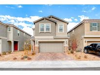 Two-story house with gray siding, stone accents, and a two-car garage at 2986 Gallarate Dr, Henderson, NV 89044