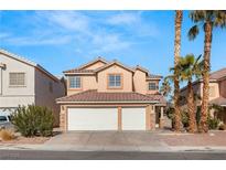Two-story house with two-car garage and desert landscaping at 4712 Stable Way, North Las Vegas, NV 89032
