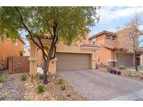 Two-story house with neutral color scheme and landscaped front yard at 7481 Benlomond Ave, Las Vegas, NV 89179
