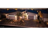 Modern home with a sleek design, city views, and palm trees at 794 Willits St, Las Vegas, NV 89138