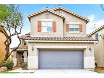 Two-story house with attached garage and landscaping at 989 Crescent Falls St, Henderson, NV 89011