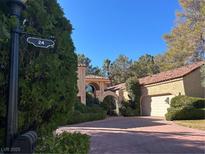 Charming home with a beautiful driveway and well-manicured landscaping at 24 Wild Dunes Ct, Las Vegas, NV 89113