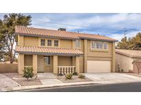 Two-story house with tan exterior, tile roof, and attached two-car garage at 275 Adorno Dr, Henderson, NV 89074