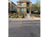 Two-story house with landscaped yard and walkway at 3041 Savella Ave, Henderson, NV 89044