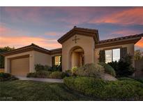 Single-story home with a two-car garage and landscaped yard at 37 Stonemark Dr, Henderson, NV 89052