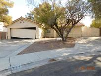 Single-story house with a driveway and mature trees at 384 Norlina Ct, Henderson, NV 89014