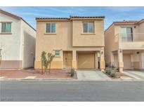 Tan two-story house with attached garage and small front yard at 4070 Emerald Wood St, Las Vegas, NV 89115