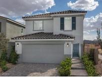 Two-story house with gray siding, a two-car garage, and landscaping at 4199 Nopal Serrano Ave, Las Vegas, NV 89141