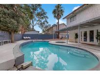 Backyard pool area with mature landscaping and patio with outdoor seating, perfect for relaxing and entertaining at 4330 Flandes St, Las Vegas, NV 89121