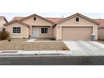 Single-story house with a two-car garage and desert landscaping at 4618 Zia Ridge St, North Las Vegas, NV 89031