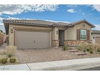 Single-story home with a two-car garage and landscaped front yard at 473 Harvest Rain Ave, Henderson, NV 89011